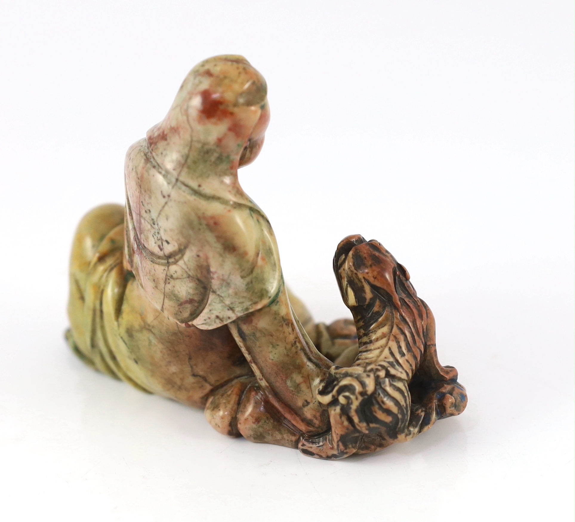 A Chinese soapstone group of a seated luohan and lion-dog, 19th/20th century